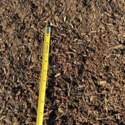 Darby Pit, Gravel & Trucking - We specialize in providing premium materials such as dirt, sand, gravel, and crushed stone, alongside top-notch trucking services tailored for excavation, landscaping, home builders, and infrastructure projects like making roads, paths, driveways, and foundations. In our portfolio of resources is Soil Pep (available in 20-yard loads). Imagine a close-up of a measuring tape on a surface covered with this high-quality material—capturing an accurate measurement of roughly 8 inches—illustrating the precision and quality you can expect from our services.