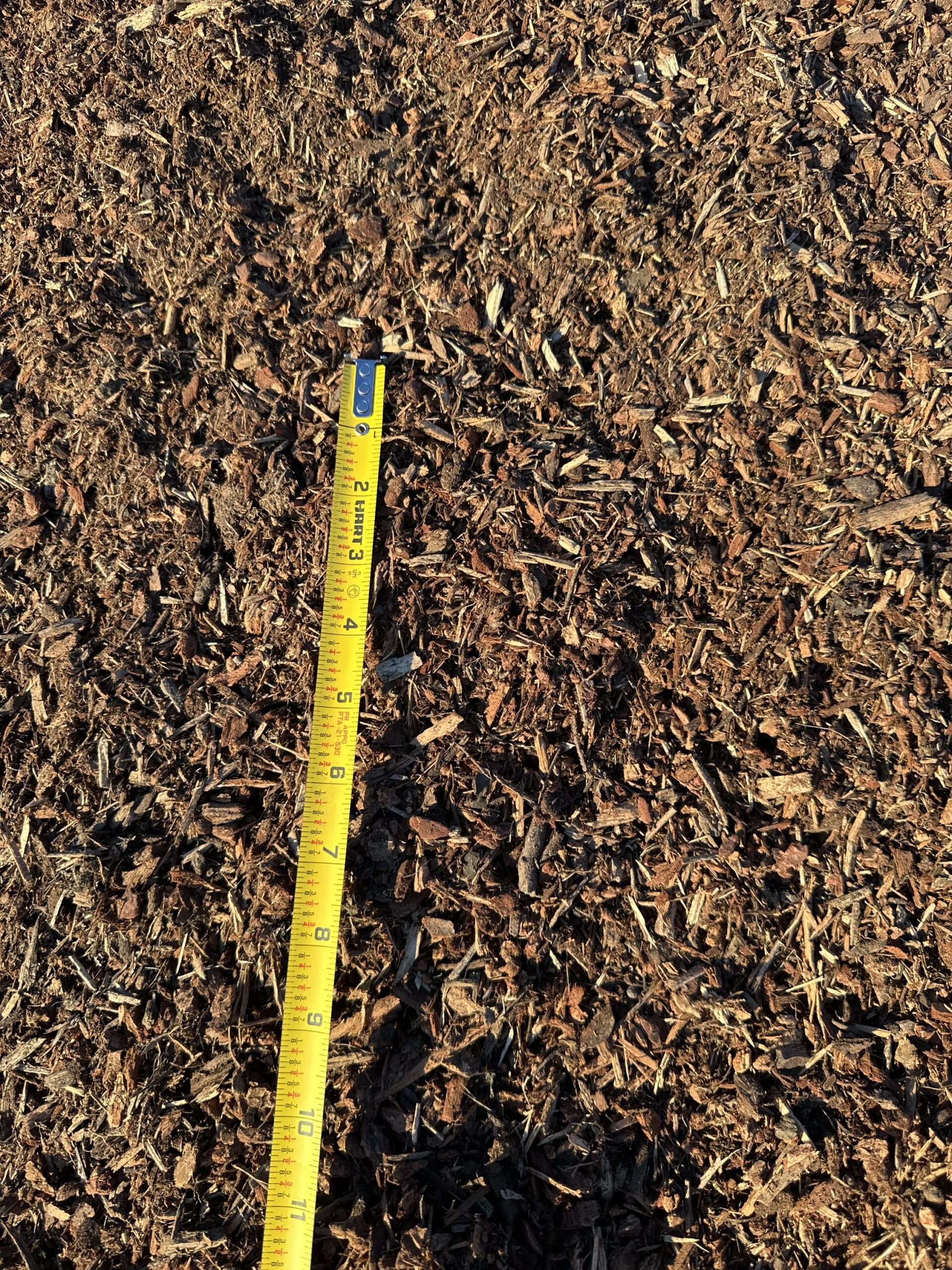 Darby Pit, Gravel & Trucking - We specialize in providing premium materials such as dirt, sand, gravel, and crushed stone, alongside top-notch trucking services tailored for excavation, landscaping, home builders, and infrastructure projects like making roads, paths, driveways, and foundations. In our portfolio of resources is Soil Pep (available in 20-yard loads). Imagine a close-up of a measuring tape on a surface covered with this high-quality material—capturing an accurate measurement of roughly 8 inches—illustrating the precision and quality you can expect from our services.